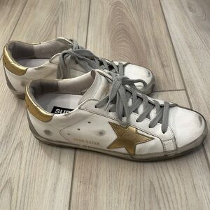Golden Goose Women's White and Gold Trainers